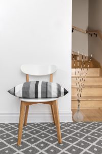Chair with cushion in a room with staircase
